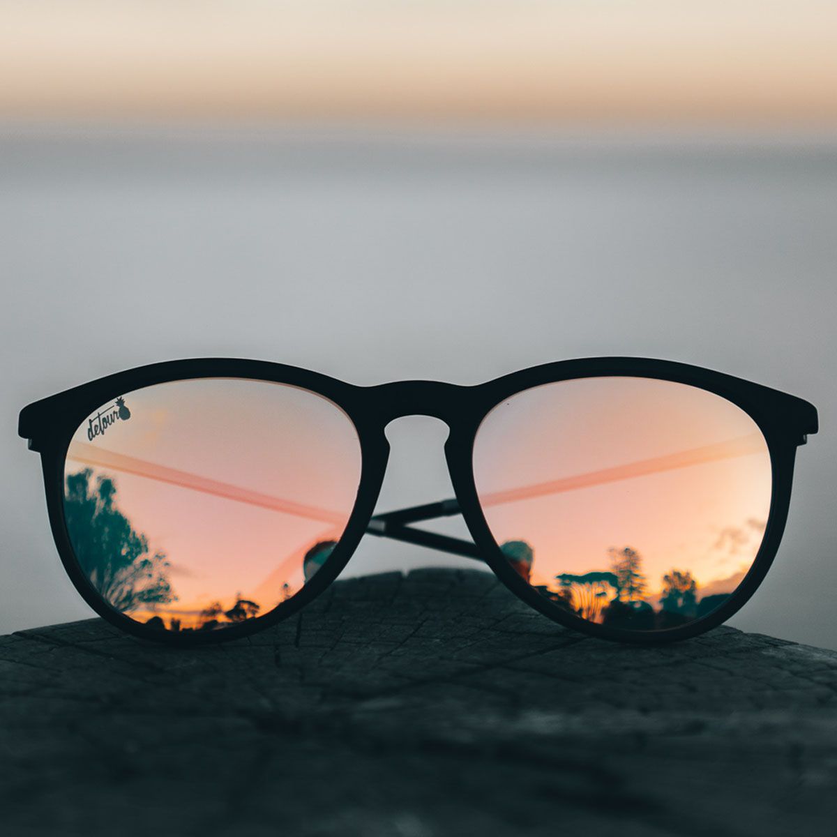 how detour sunglasses focused on community to grow its brand blog - image of sunglasses with a sunset in the reflection