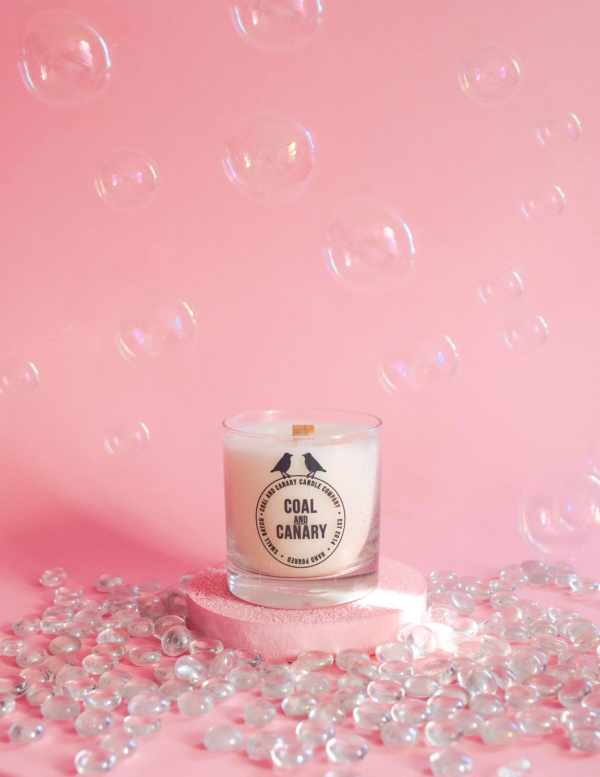 Ingredients that Smell Good with Coal and Canary photo of a single candle against a pink backdrop