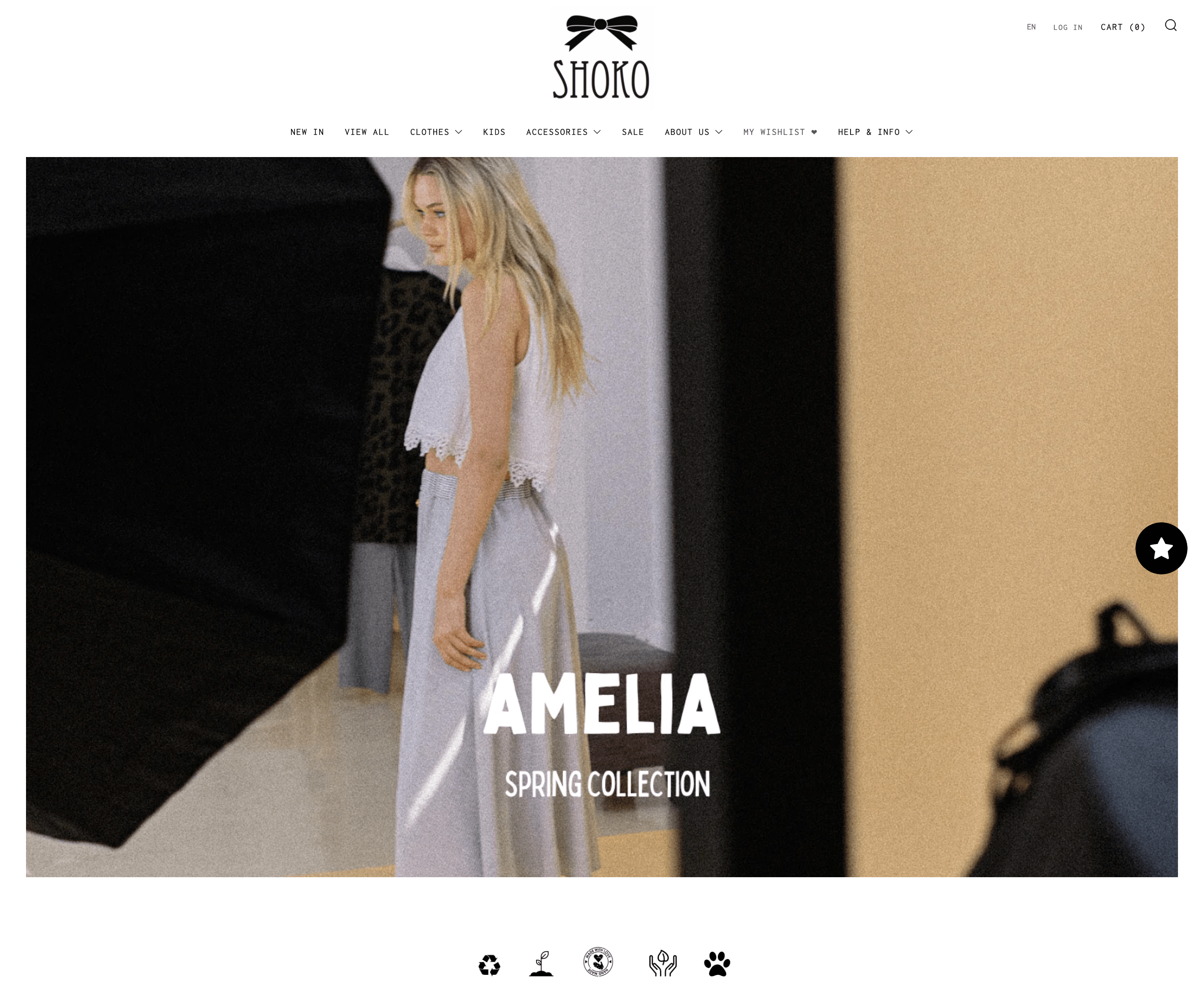 Sustainable brands–Shoko’s website homepage showing a grainy, retro style image of a blonde woman wearing a white lacy shirt and grey maxi skirt. The text overlaying the banner image says Amelia: Spring Collection. 