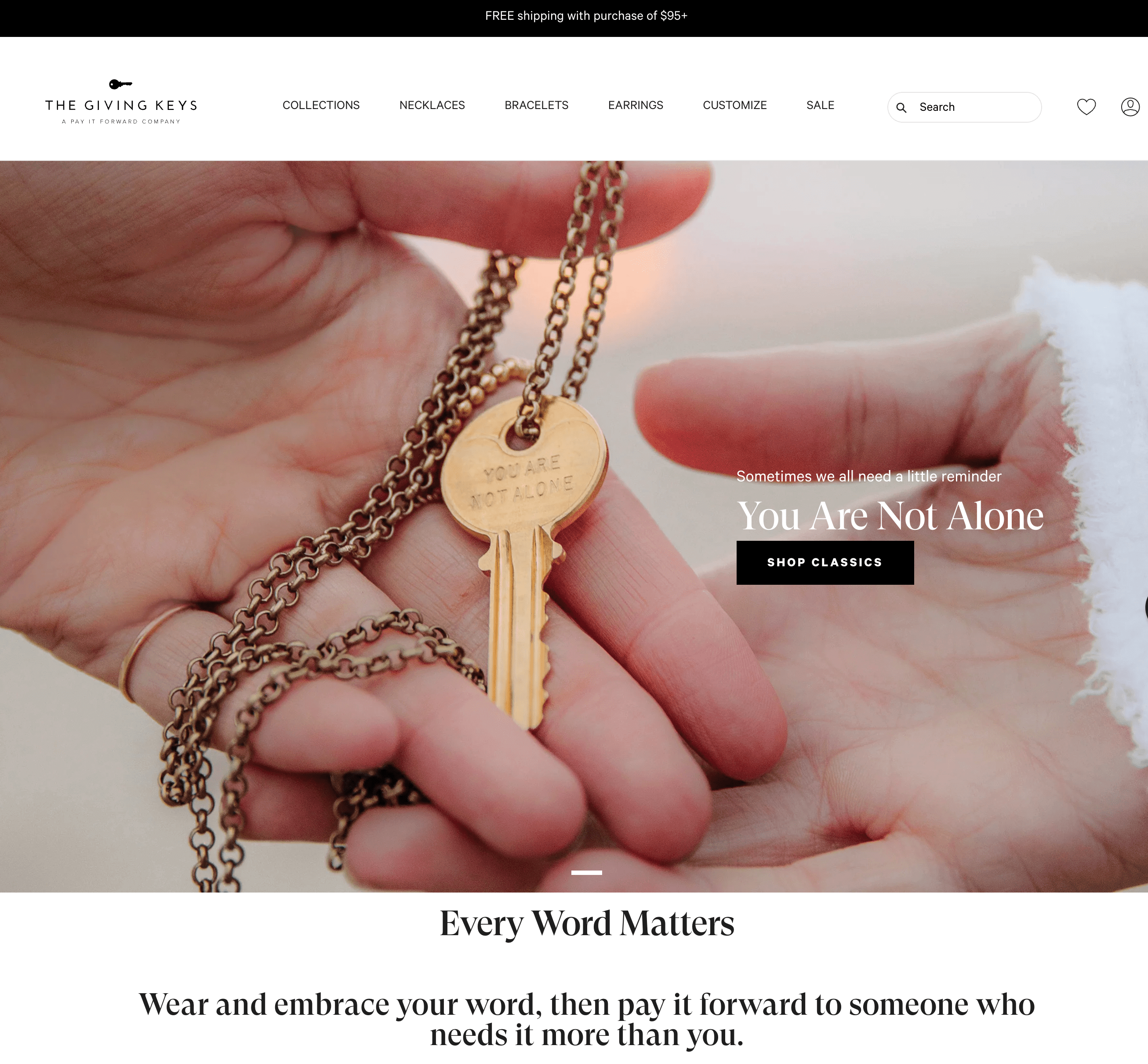 Storytelling Brands–The Giving Keys’ homepage text: Every Word Matters. Wear and embrace your word, then pay it forward to someone who needs it more than you. Above the text is a banner image of a hand placing a gold key necklace engraved with the words: You Are Not Alone, in someone else’s hand. 