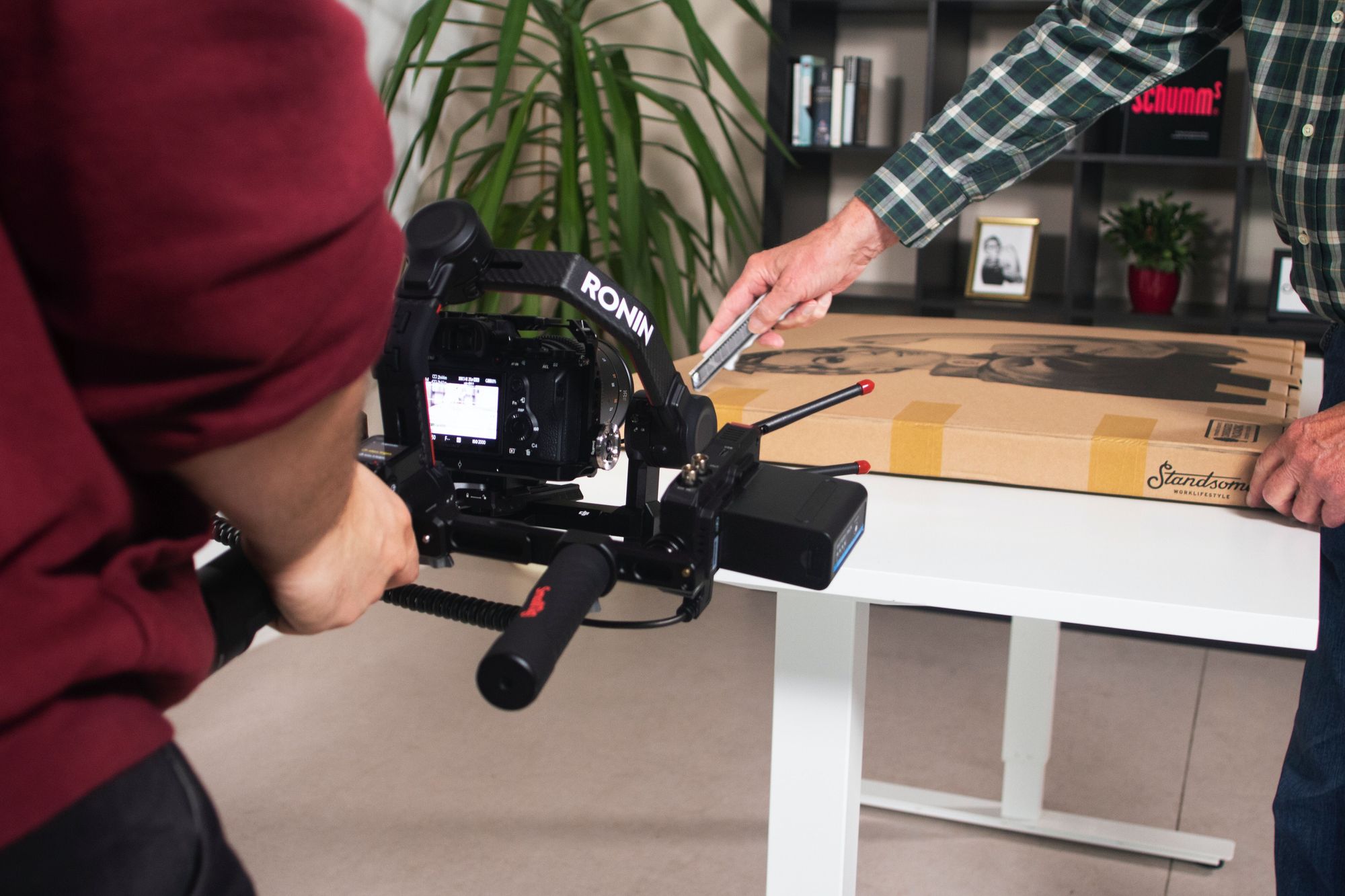 image of a camera man recording an unboxing video