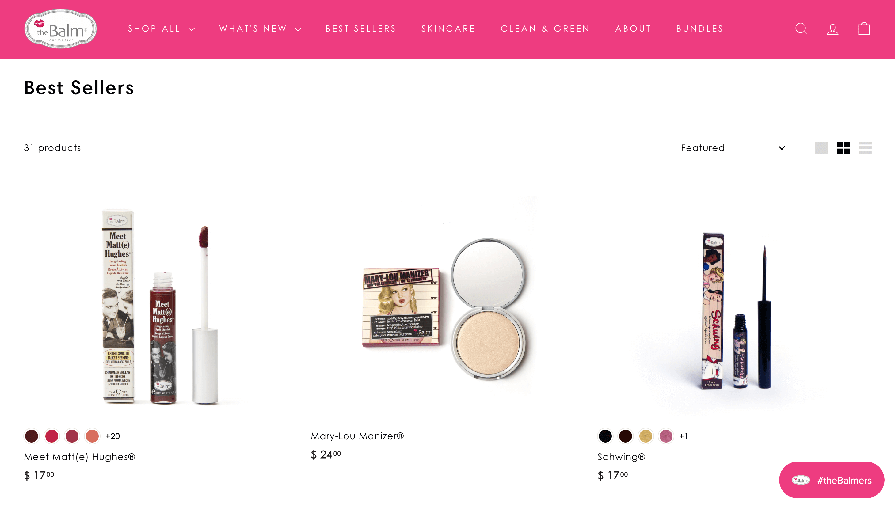 A screenshot of a product page on The Balm’s website showing 3 makeup products. They are all branded in a comic-book-like style of packaging. 