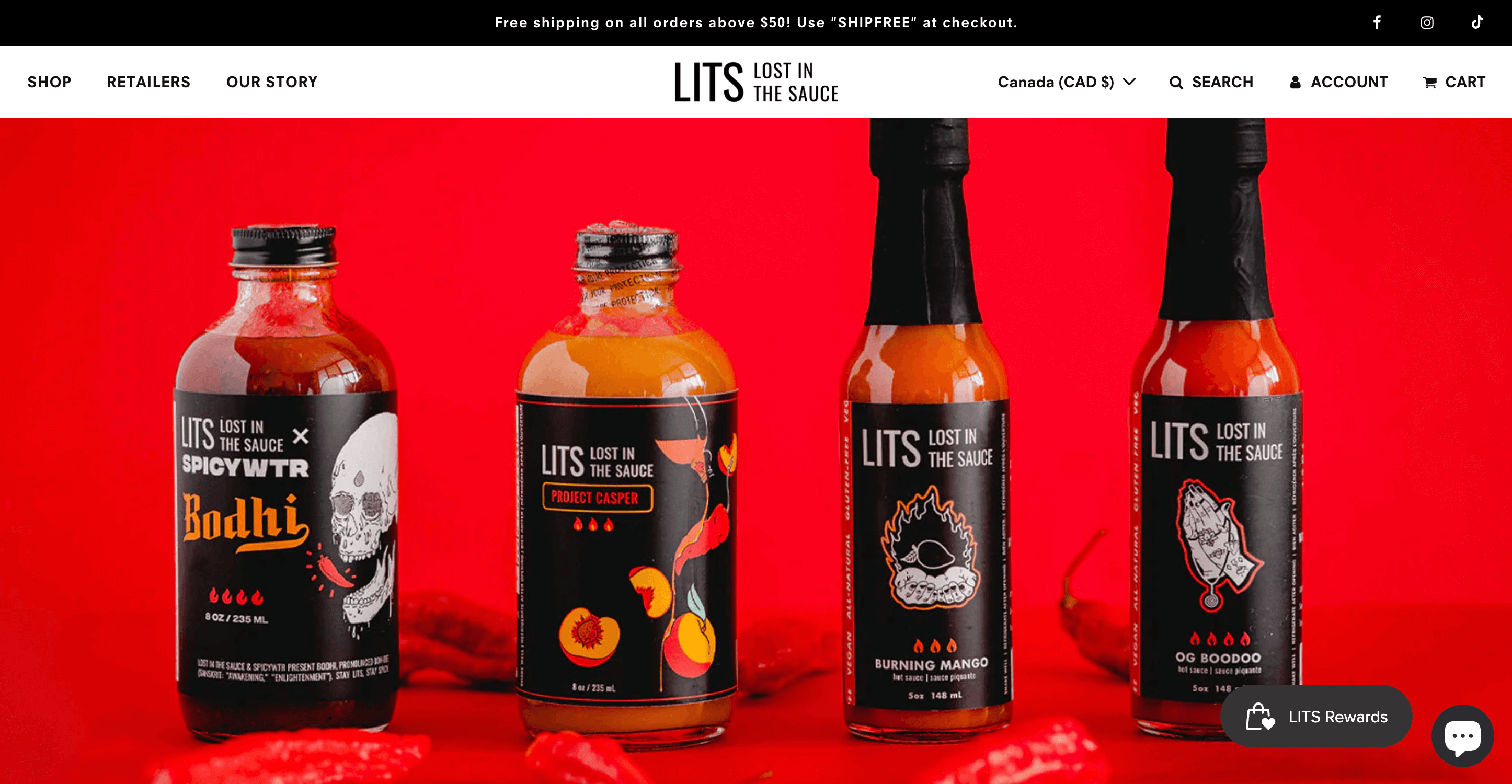 Valentine’s Day Gift Guide–A screenshot from Lost in the Sauce’s homepage. The banner image shows 4 of its sauce bottles in front of a red background with chili peppers surrounding them. 