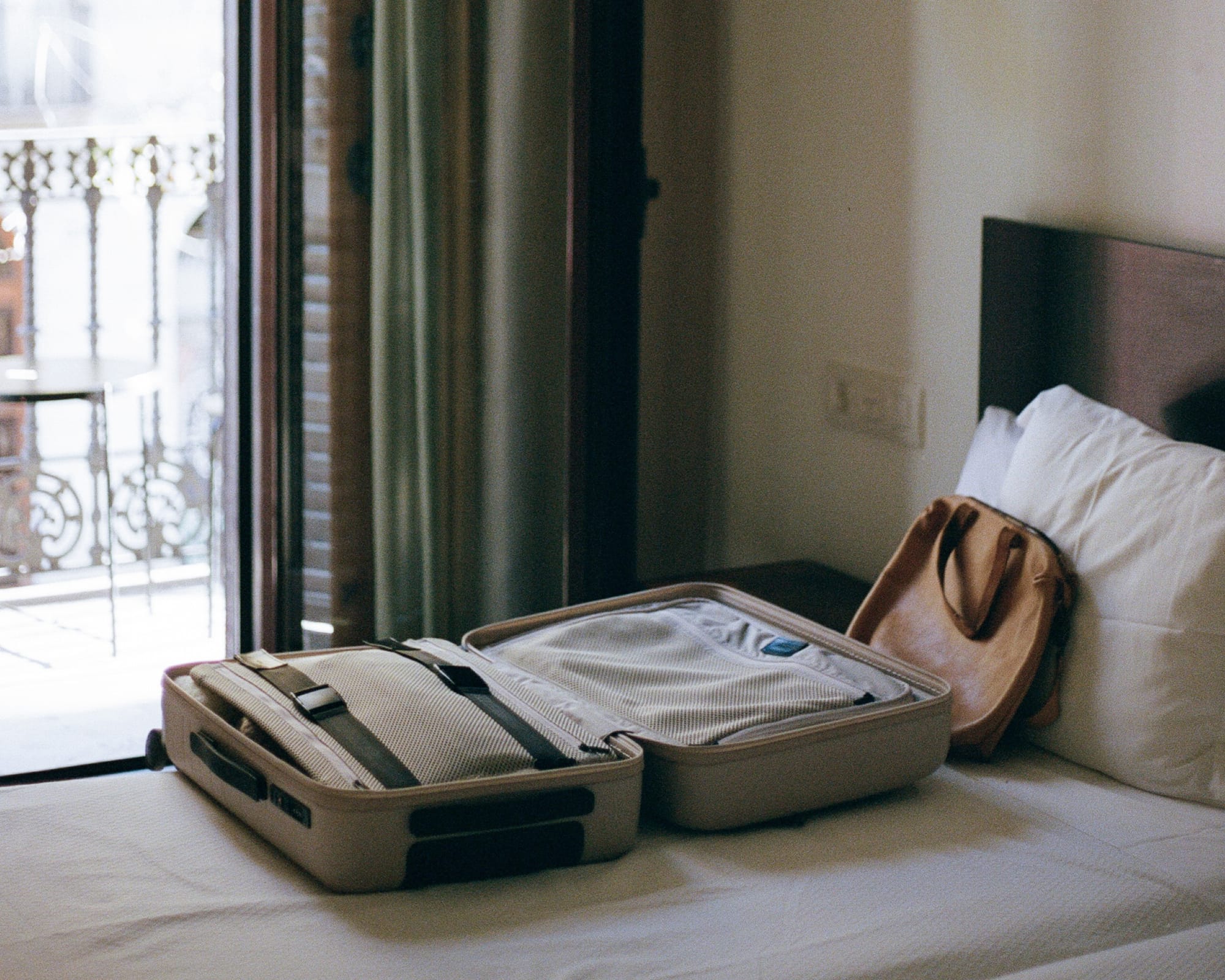 picture of a monos luggage on top of a bed